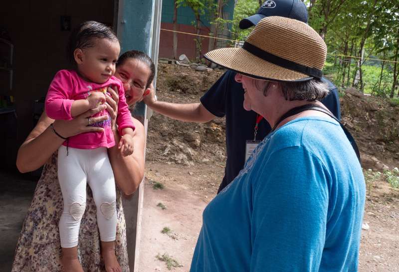 Visitors on a mission trip to Honduras visit a family in their home