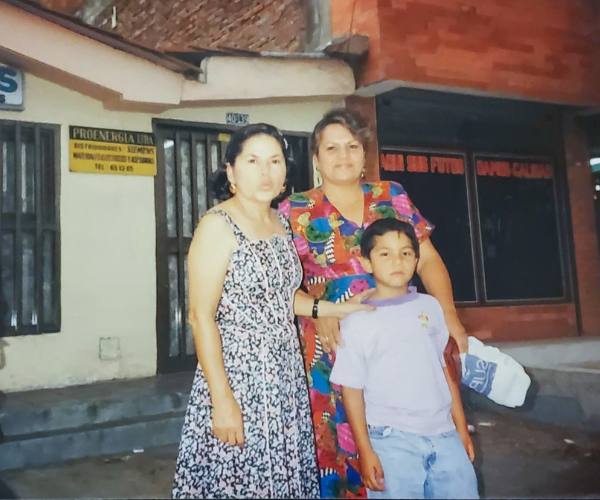 6-year-old Daniel Patiño stands with his mom and aunt in Colombia
