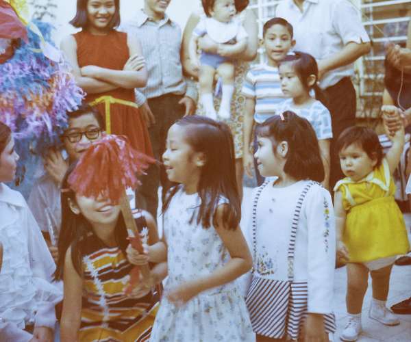 Sandra Chavez Quan hits a pinata surrounded by family