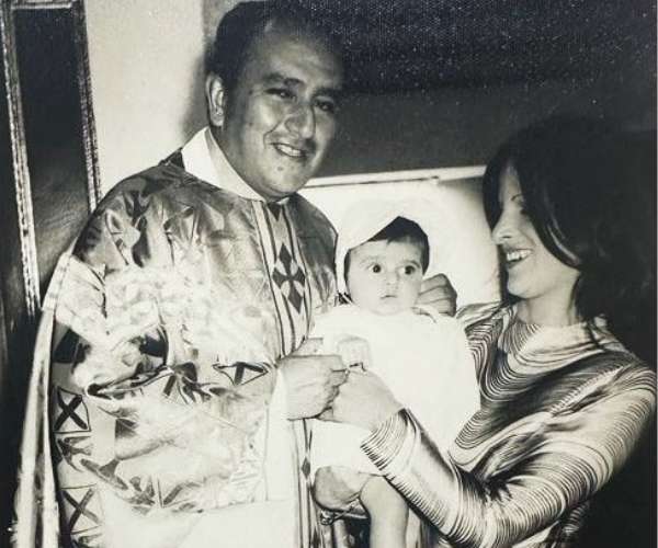 baby being held by mother at baptism