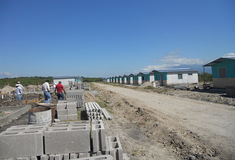 People gathered around a construction site, watching the ongoing work.